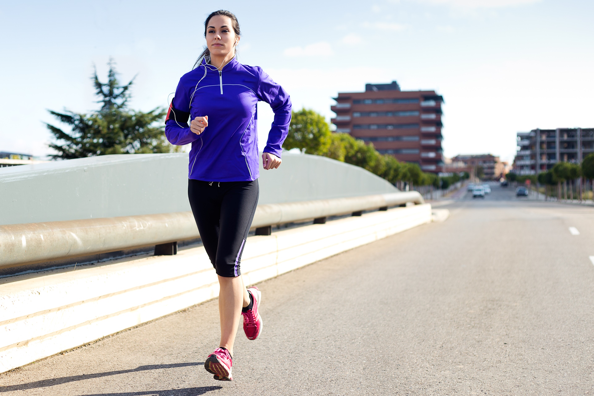 Female runner with city background